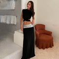 Elegant Backless Top Paired With A Patchwork Maxi Skirt